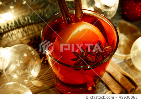 Mulled wine in a glass on a wooden background Mulled wine in a glass on a wooden background 45930063