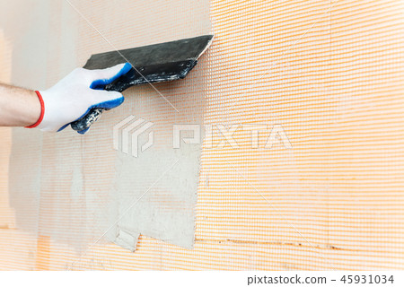 The worker's hand with a wide spatula. 45931034