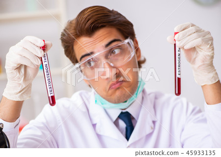 Young handsome lab assistant testing blood samples in hospital Young handsome lab assistant testing blood samples in hospital 45933135