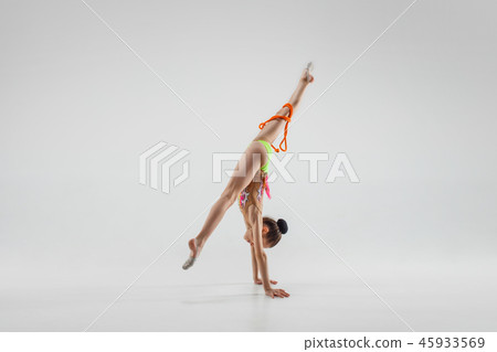 The teenager girl doing gymnastics exercises isolated on white background 45933569
