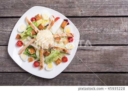 Salad ceasar with chicken , eggs and tomatoes 45935228