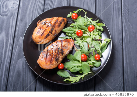 Grilled chicken with spinath and tomatoes salad Grilled chicken with spinath and tomatoes salad 45935970