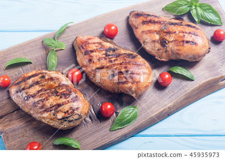 Grilled chicken breast fillet with basil tomatoes Grilled chicken breast fillet with basil tomatoes 45935973