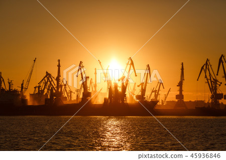 Many big cranes silhouette in the port of Azov sea Many big cranes silhouette in the port of Azov sea 45936846