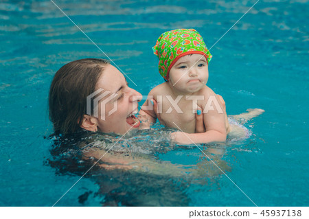 mother and daughter playing in swimming pool mother and daughter playing in swimming pool 45937138