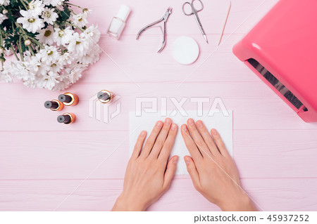 Young woman's hands near UV lamp Young woman's hands near UV lamp 45937252