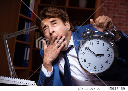 Young businessman working in the office at night  45938469