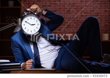 Young businessman working in the office at night Young businessman working in the office at night 45938473