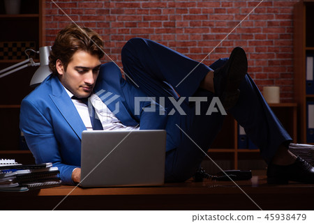 Young businessman working in the office at night Young businessman working in the office at night 45938479
