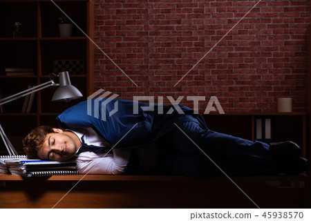 Young businessman working in the office at night Young businessman working in the office at night 45938570