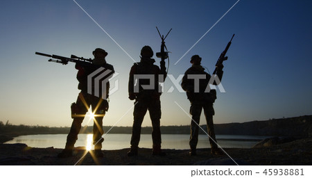 Three soldiers posing with guns 45938881