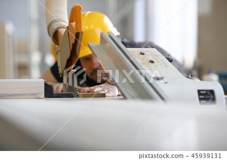 Worker using electric saw portrait Worker using electric saw portrait 45939131