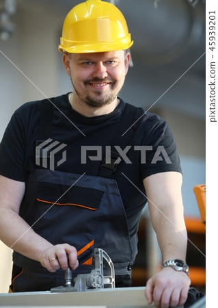 Worker using electric saw portrait Worker using electric saw portrait 45939201