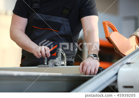 Worker using electric saw portrait Worker using electric saw portrait 45939205