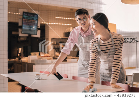 Young couple working part time job as waiters in the restaurant 45939275