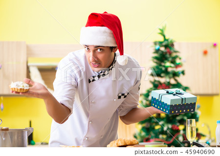 Young chef husband working in kitchen at Christmas eve  45940690