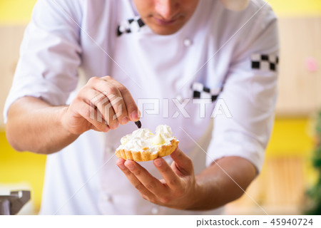 Young chef husband working in kitchen at Christmas eve  45940724