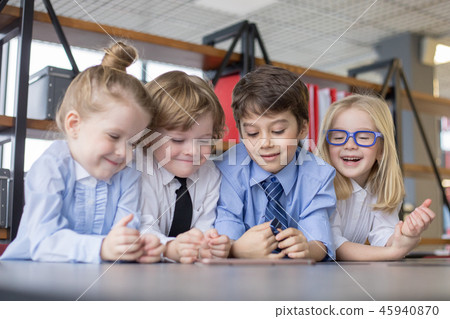 Little children businessmen sharing ideas in office. Little children businessmen sharing ideas in office. 45940870