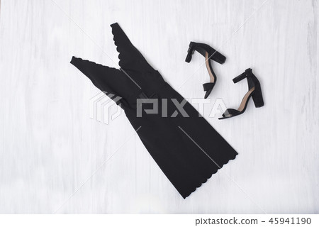 Little black dress and shoes on wooden background 45941190