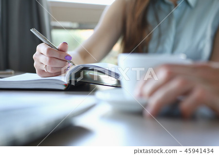 business people in cafe coffee break at table hold cup of coffee in arm 45941434