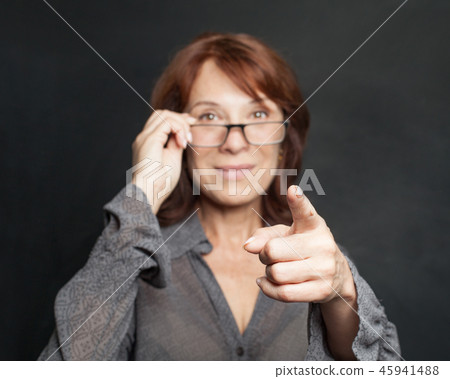 Pointing hand of business woman on black Pointing hand of business woman on black 45941488