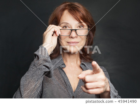 Happy business woman in glasses pointing Happy business woman in glasses pointing 45941490