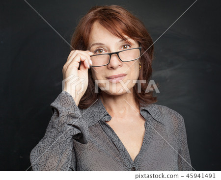 Confident mid adult business woman in glasses Confident mid adult business woman in glasses 45941491