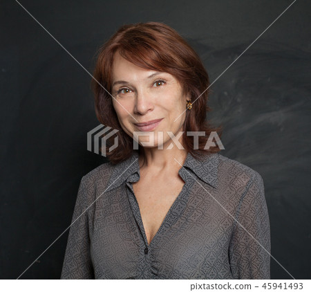 Happy mature woman on black background Happy mature woman on black background 45941493