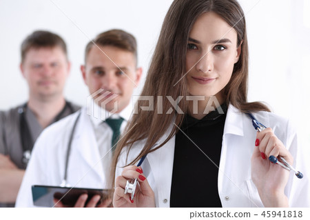 Group of medics proudly posing in row and Group of medics proudly posing in row and 45941818