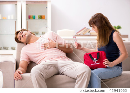 Young family getting treatment with first aid kit Young family getting treatment with first aid kit 45941963