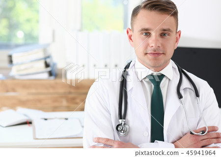 Male medicine doctor his chest in office Male medicine doctor his chest in office 45941964