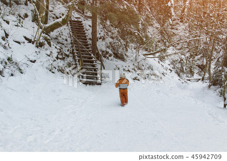 Little boy in an orange jumpsuit standing Little boy in an orange jumpsuit standing 45942709