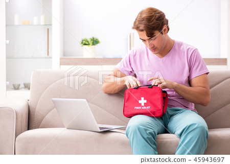 Sick man at home with first aid kit 45943697