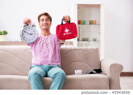 Sick man at home with first aid kit 45943699