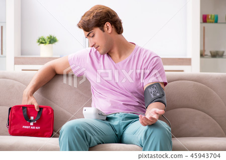 Sick man at home with first aid kit 45943704