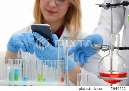 A female doctor in a chemical laboratory holds 45944232