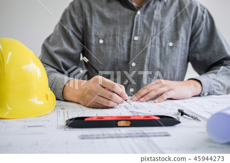 Construction engineering or architect hands working on blueprint 45944273