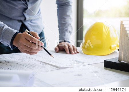 Construction engineering or architect hands working on blueprint 45944274