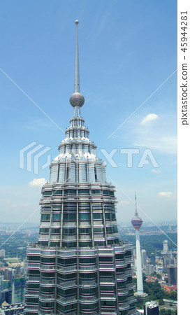 KUALA LUMPUR, MALAYSIA - APR 12th 2015: Detail of top of Petronas towers in Kuala Lumpur viewed KUALA LUMPUR, MALAYSIA - APR 12th 2015: Detail of top of Petronas towers in Kuala Lumpur viewed 45944281