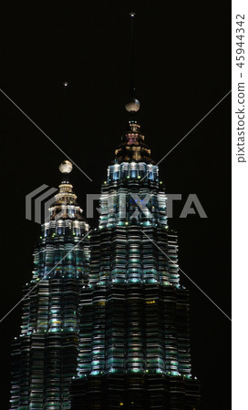 KUALA LUMPUR, MALAYSIA - APRIL 13: Petronas Twin Towers and city at night scene. 45944342