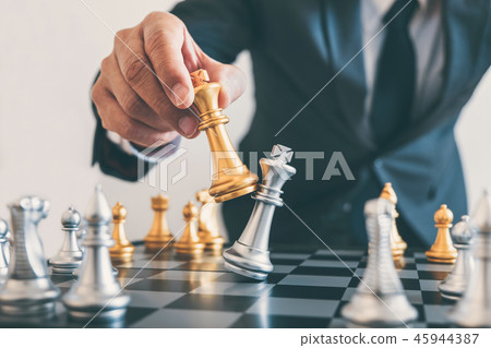 Businessman leadership playing chess and thinking strategy plan 45944387