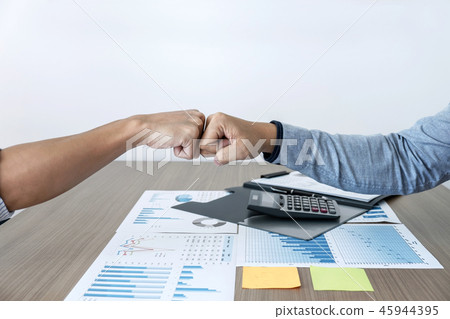 Finishing up a meeting, giving first bump of hand's two happy bu 45944395