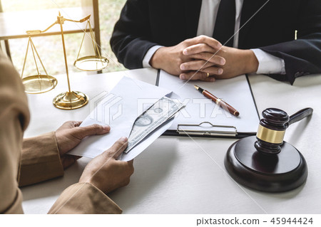 Business woman giving bribe money the form of dollar bills to ma Business woman giving bribe money the form of dollar bills to ma 45944424