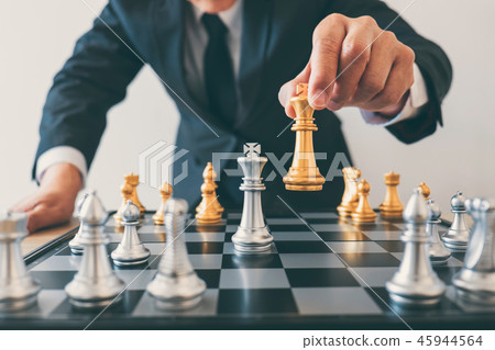 Businessman leadership playing chess and thinking strategy plan 45944564