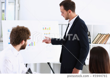 Group of people deliberate on white board 45944781