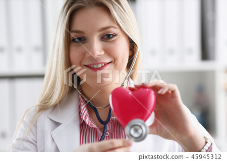 Beautiful smiling blond female doctor hold 45945312