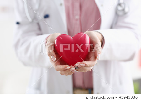 Female doctor hold in arms and cover red toy 45945330