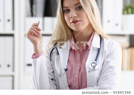 Beautiful smiling female doctor sit at workplace Beautiful smiling female doctor sit at workplace 45945346