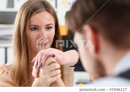 Woman and man in suit hold hands 45946227