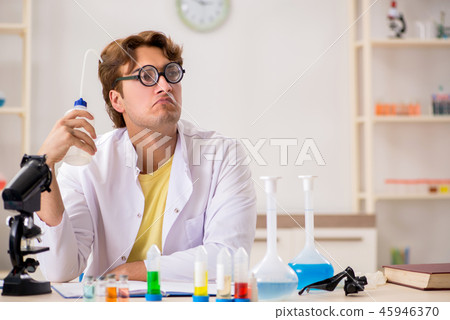 Funny crazy chemist doing experiments and tests Funny crazy chemist doing experiments and tests 45946370